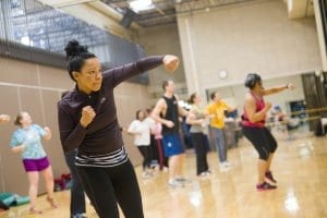 Closeup of a woman in a dance boxing fitness class offered at a gym.