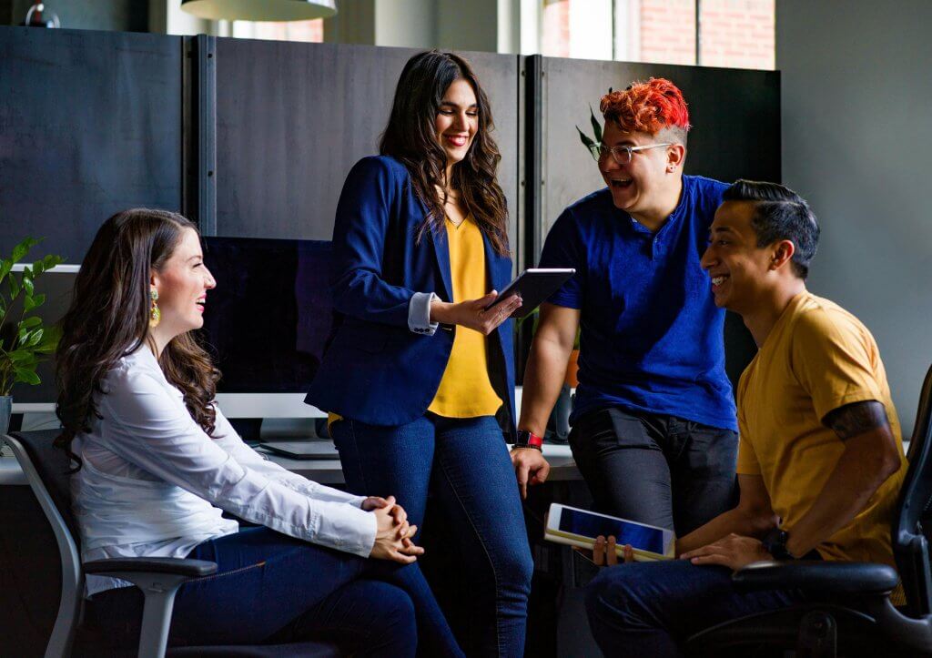 Group of four diverse coworkers discussing a wellness program.