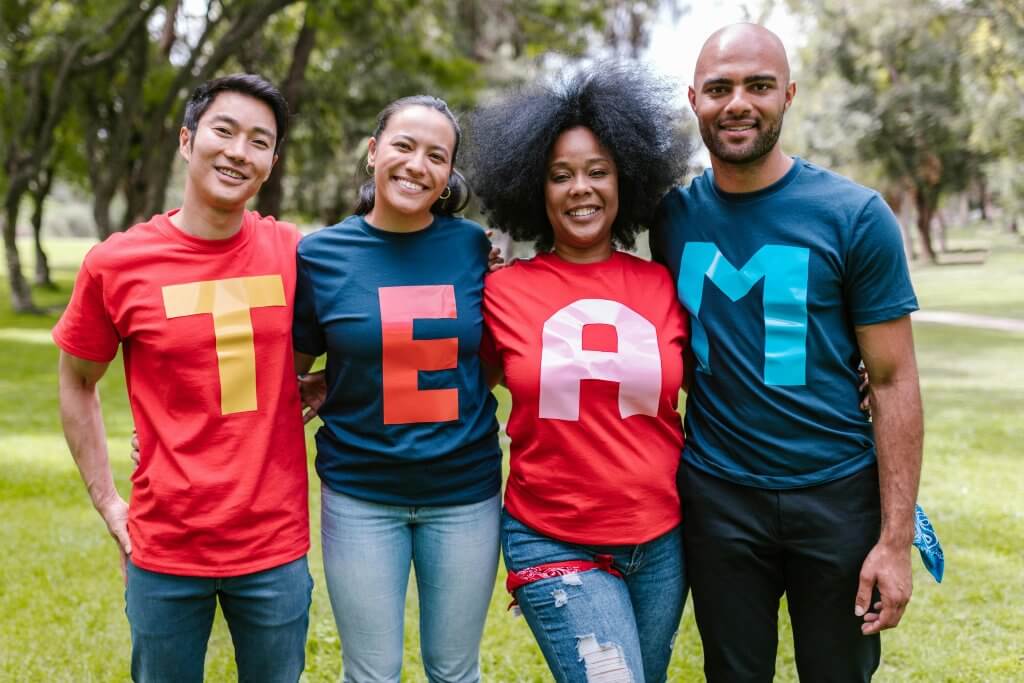 Four team members representing company in coordinating shirts.