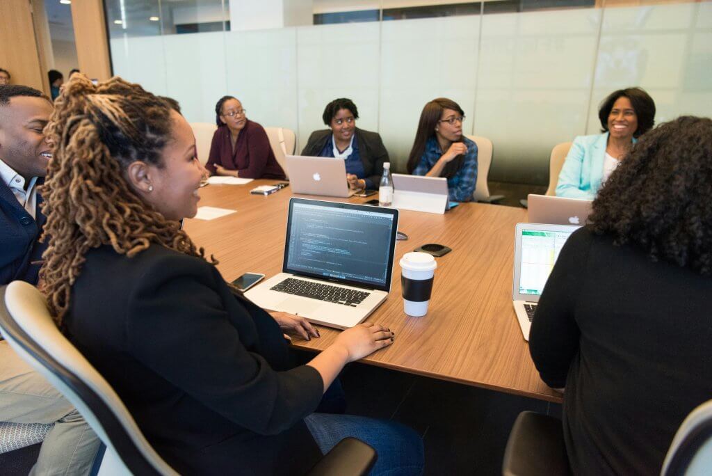 Wellness Committee meeting in a conference room to cover the current wellness program engagement.