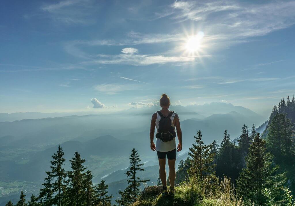 Employee summitting a hike as part of the wellness program.