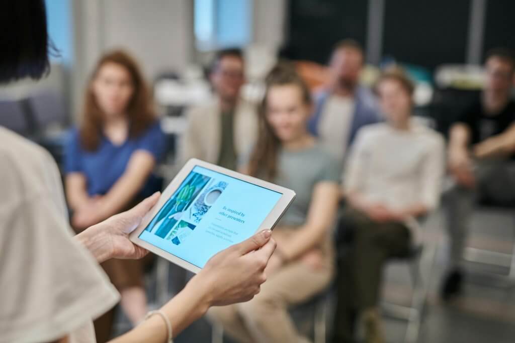 Wellness broker leads an open enrollment meeting onsite to a group.