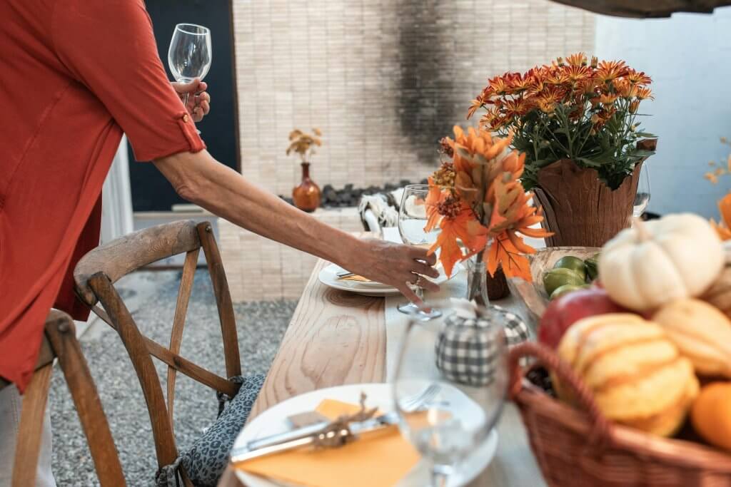 Woman preparing to host a fall holiday meal.